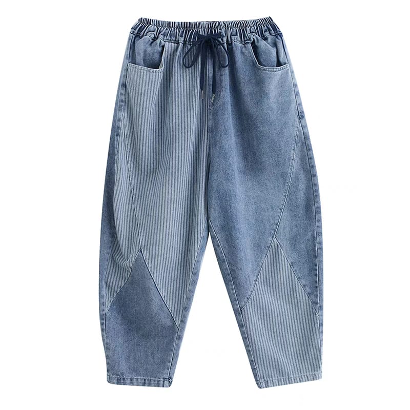 Blue denim pants with patchwork design on a white background