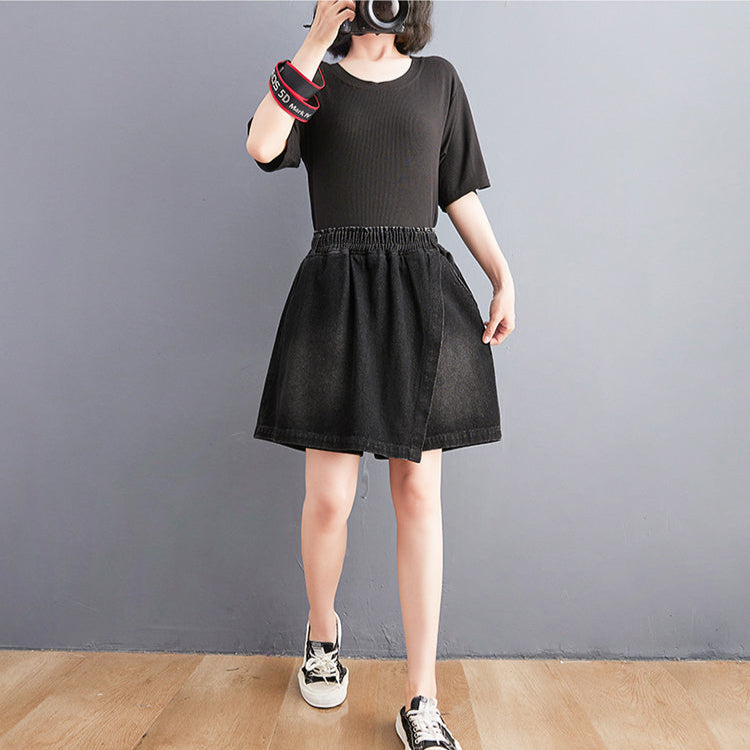 Person wearing a black dress with a plain background