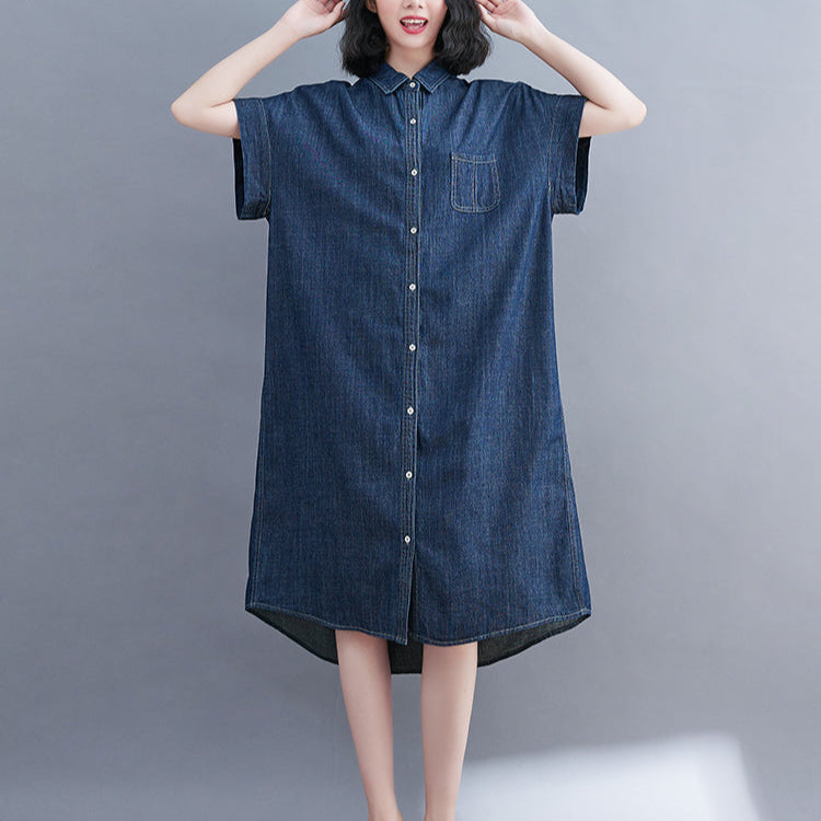 Person wearing a denim dress on a gray background