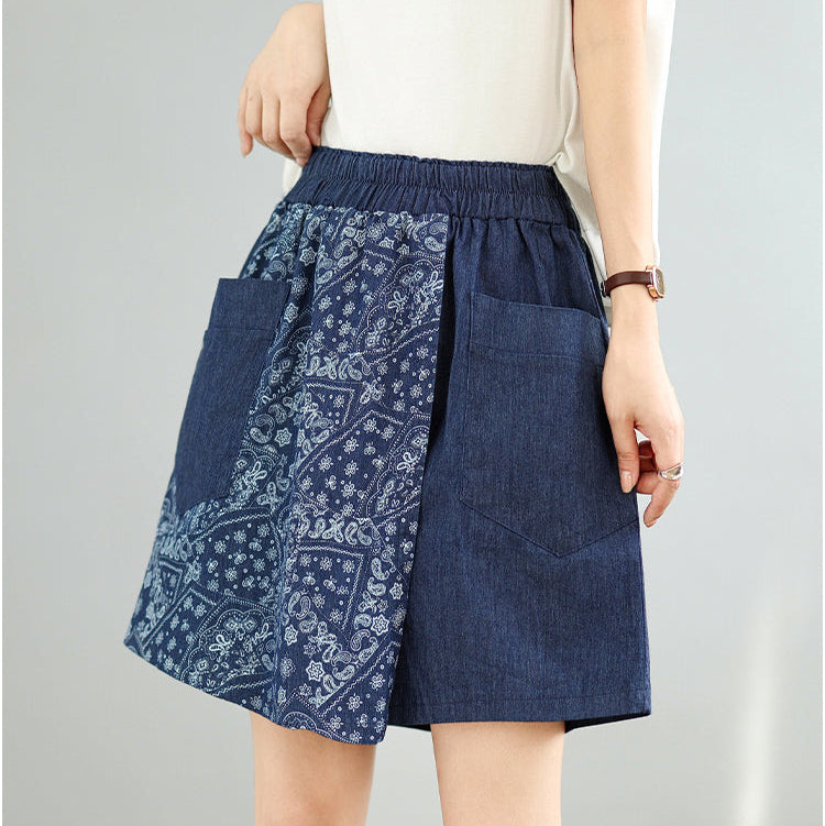 Blue denim skirt with white pattern on a gray background