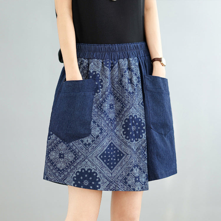 Blue patterned skirt with pockets worn by a person on a gray background