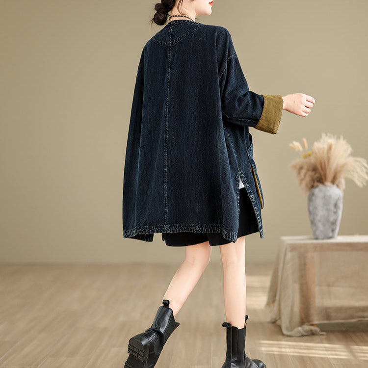 Person wearing a dark denim jacket and black boots in a room with a neutral color scheme.