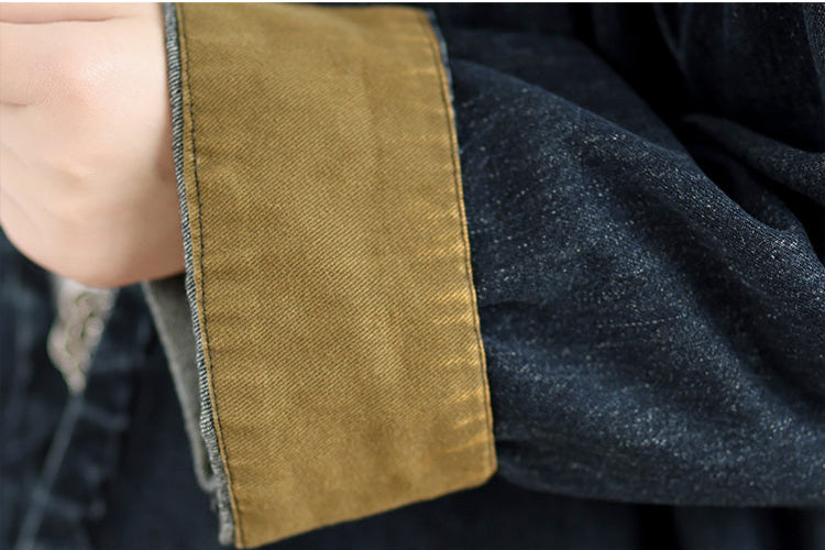 Close-up of a dark fabric garment with a brown trim