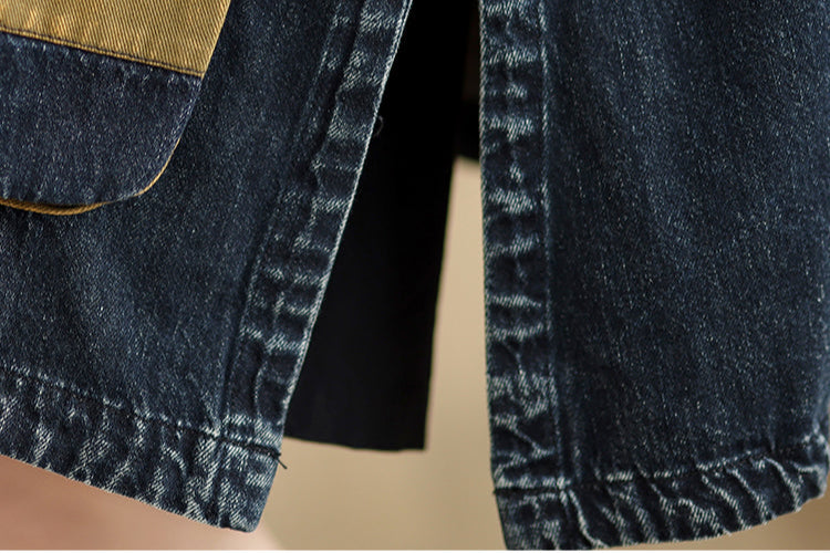 Close-up of a denim jacket with a pocket on a beige background