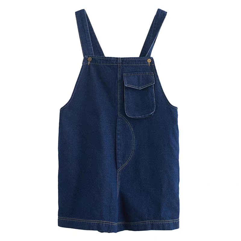 Blue denim pinafore dress on a white background