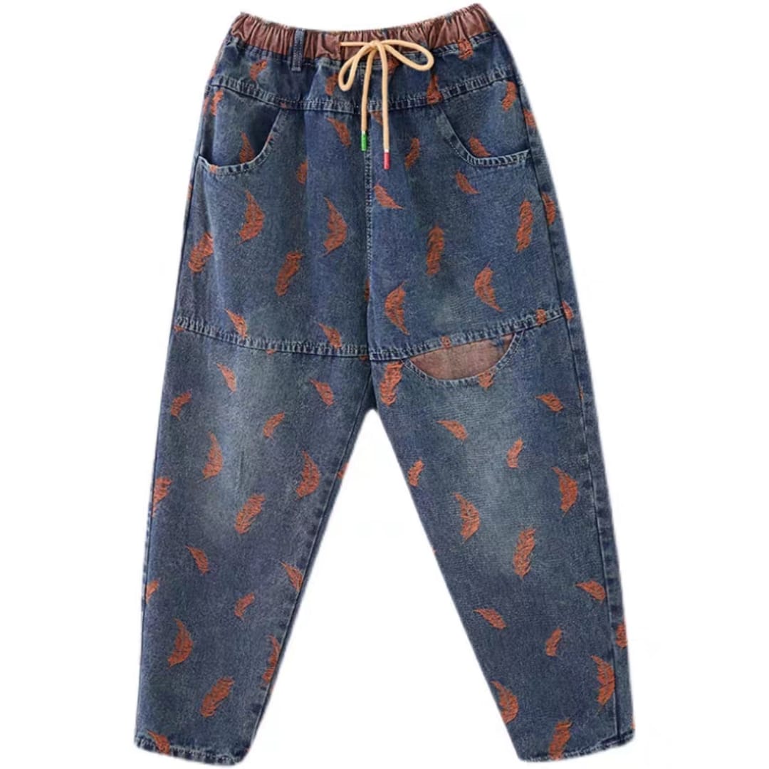 Blue jeans with brown leaf pattern on a white background