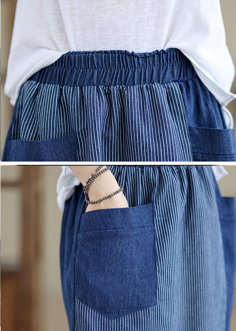 Blue striped apron worn over a white shirt with a blurred background