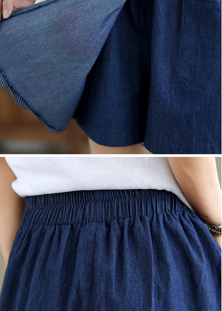 Close-up of a person wearing a blue denim skirt with a blurred background
