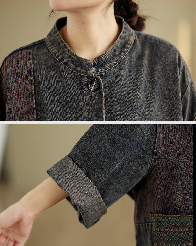 Close-up of a person wearing a dark denim jacket with a blurred background