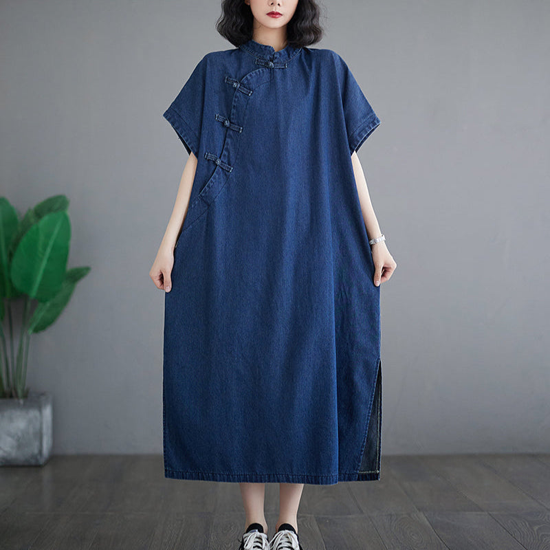 Woman wearing a blue dress standing against a gray background