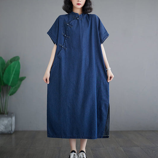 Woman wearing a blue dress standing against a gray background
