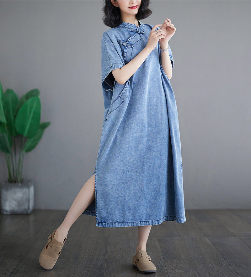 Woman wearing a blue denim dress with a gray background