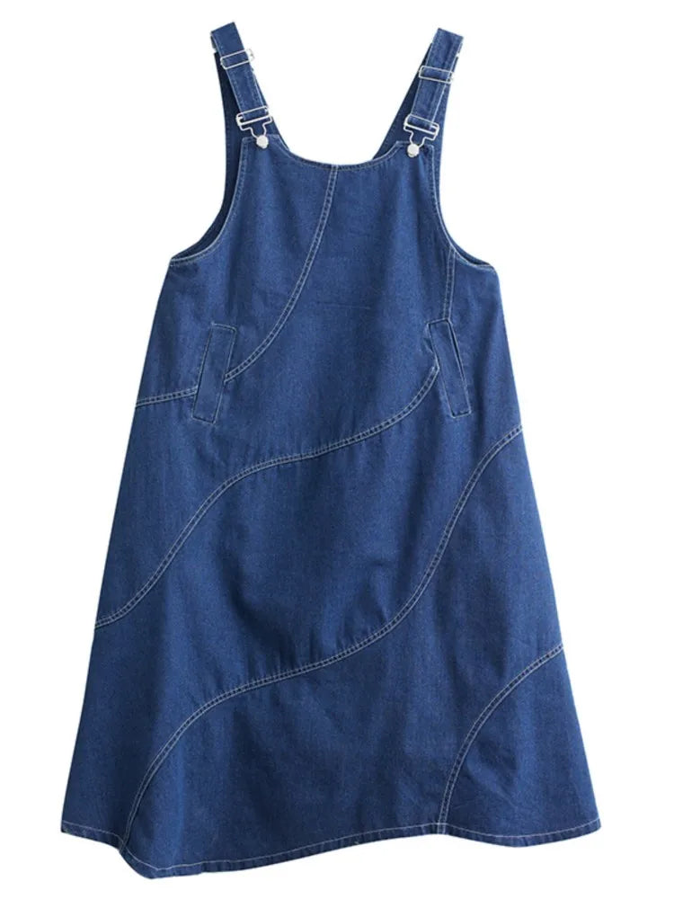 Blue denim pinafore dress on a white background