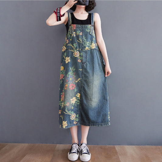 Person wearing a floral denim dress against a plain background