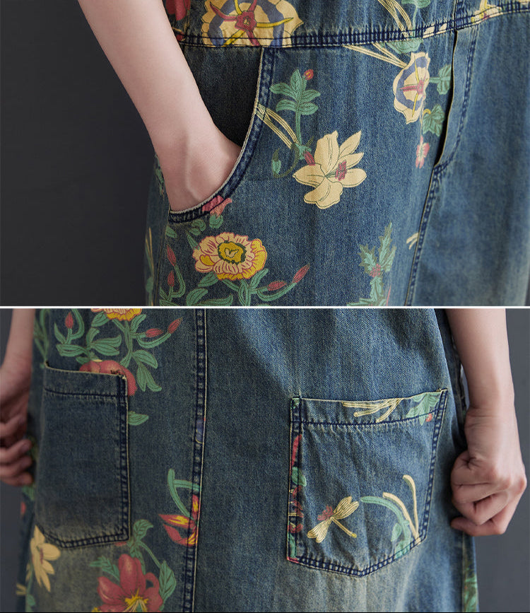 Denim dress with floral embroidery on a plain background
