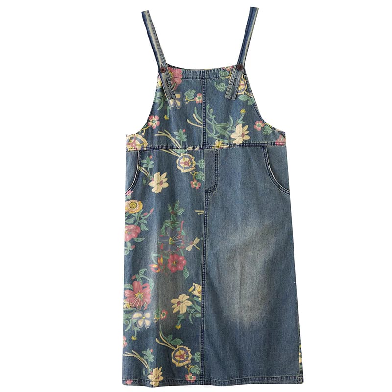 Denim pinafore dress with floral pattern on a white background