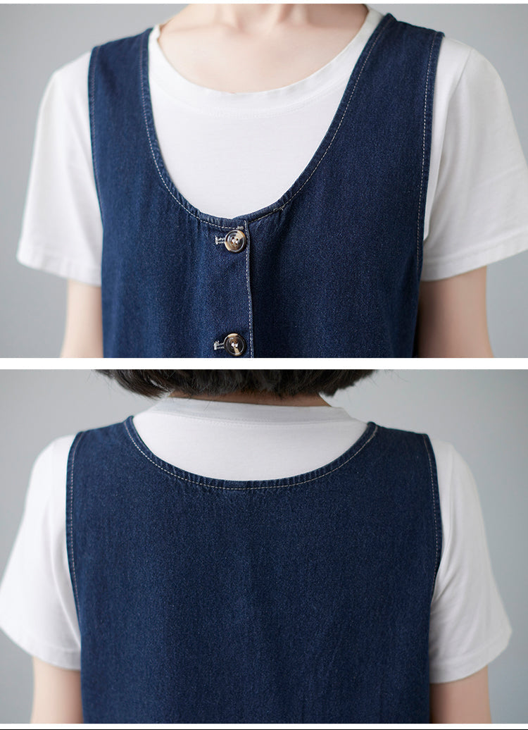 Denim vest over a white shirt on a gray background