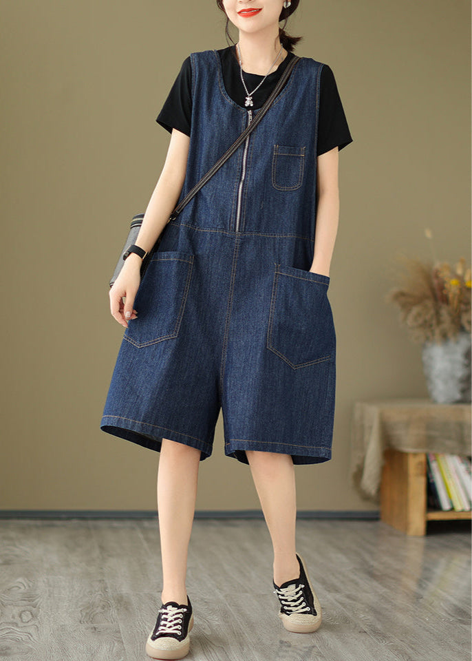 Person wearing a denim shorts over a black top in an indoor setting.
