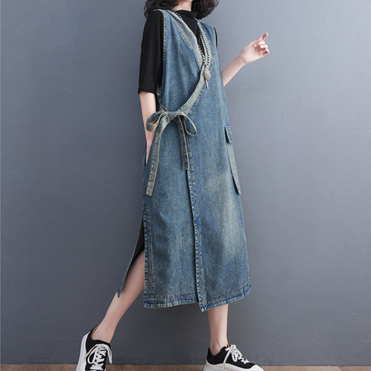 Woman wearing a denim dress with a plain background