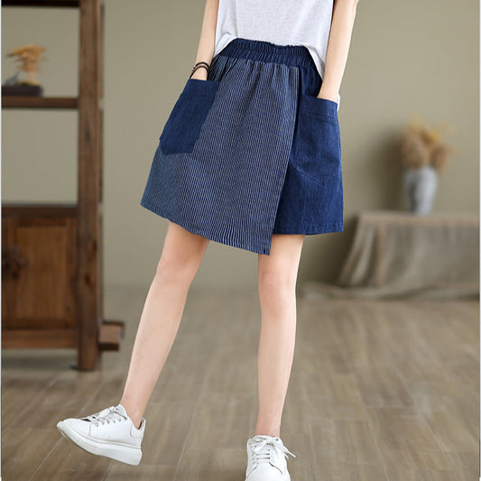 Person wearing a blue striped skirt with a white background